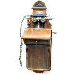 A British LM Ericsson vintage wall hanging telephone, in shaped case with domed top, chrome plated m