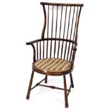 A West Country style stick back high back Windsor style chair, with a shaped cresting rail and scrol