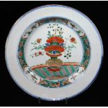 An 18thC Chinese porcelain plate, decorated with central panel of a vase of flowers in blue, green a