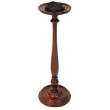 An early 20thC mahogany smokers stand, the circular top with removable section on a elongated balust