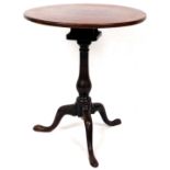 A George III mahogany one piece birdcage action tripod table, on plain baluster stem terminating in