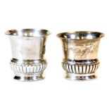 A matched pair of early 20thC silver vases, each of campana form, partially gadrooned on circular fe