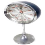 A retro Japanese Rhythm mantel clock, in oval case on an inverted stem and circular foot, with horiz