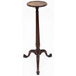 An early 20thC mahogany plant stand, the circular top on a fluted stem terminating in triple acanthu