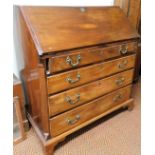 An 18thC mahogany bureau, the plain fall with oval lock revealing a fitted interior with central cup