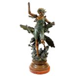 A late 19thC Stincelle Divine cast metal figure of a lady, before peacock on a naturalistic base wit