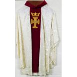 An ecclesiastical vestment robe, with crown and cross motif on a red ground, with white body, 133cm