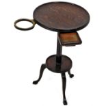 A 1920's oak drinks stand, the circular top with an articulated pull out section rotating on a circu
