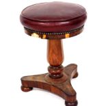 A Victorian rosewood framed piano stool, with a circular top in red leather, partially studded, on a