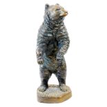 A Black Forest style figure of a standing bear, with textured coat, on shaped base, unsigned, 36cm h