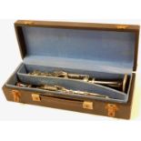 A 20thC Martin Freres French three piece clarinet, with additional mouthpiece, partially ebonised wi