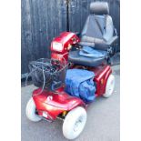 A Rascal 4-wheel 850 mobility scooter, in red colour way, with front basket, wire, battery pack and