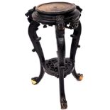 A 19thC Chinese ebonised plant stand, of circular form with S scroll dragon stiles, joined by a carv