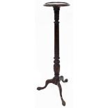 An early 20thC stained plant stand, the moulded bead lined top raised on a reeded stem terminating i