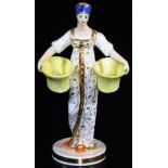 A Russian Gardner double salt figure, formed as a lady in flowing robes holding yellow salts, on a c