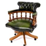 A late 20thC office captain's style swivel chair, with shaped back and arms, baluster supports, serp