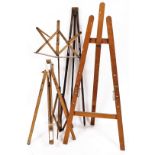 A pine stained folding artist's easel, with plain back, another by Reeves and Son, of shaped articul
