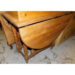 A reconstituted pine D end gate leg dining table, on turned legs, (when closed) 80cm high, 91cm wide