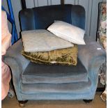 A late Victorian wing style armchair of turned front legs in later blue material, 95cm wide.