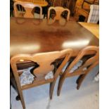 A matched dining room suite, comprising walnut finish draw leaf table with shaped top on cabriole le