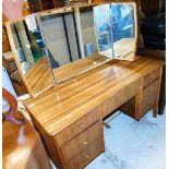 A Melamine style tiger wood finish mirror back dressing table, with three frieze drawers and four pe