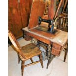 An early 20thC freestanding treadle sewing machine, on iron base, 76cm high, 89cm wide, 43cm deep, a