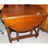 A 20thC oak barley twist gate leg table, (when closed) 74cm high, 74cm wide, 38cm, deep.