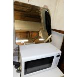 A Panasonic NN-T553W microwave, 32cm high, 54cm wide, 34cm deep, and a hanging mirror.