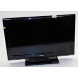 A Toshiba 23 inch colour television, in black trim with remote control and wire.
