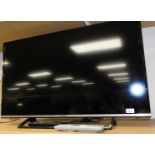 A Panasonic 40 inch colour television, in black and chrome coloured trim with remote controls and wi