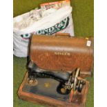 An early 20thC oak cased Singer sewing machine, and various jigsaws.