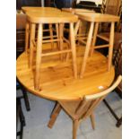 A pine circular topped table, 77cm high, 98cm diameter, stick back Ercol style lightwood chair and f