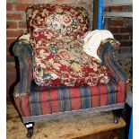 A late Victorian armchair, with upholstered back and seat in later stripe material with a Howard sty