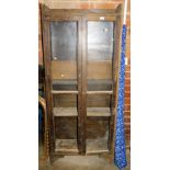 An early 20thC oak stained bookcase with two glazed doors, 181cm high, 77cm wide, 30cm deep, and a r