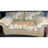 A two seater settee in floral pattern material, 168cm wide.