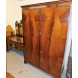 A matched two piece bedroom suite, comprising two door wardrobe with oval flame mahogany style panel