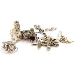 A small selection of silver and silver palted charms and pendants, comprising a carriage, a train, a