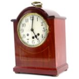 An early 20thC mahogany and boxwood strung mantel clock, with Westminster chime, the white dial with