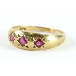 A 9ct gold dress ring, set with three illusion set garnets, ring size P, 2g all in.