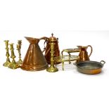 A quantity of metalware, to include three copper flagons, trivet, two handled pan, candlesticks,