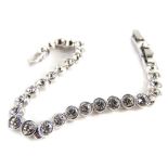 A modern Swarovski crystal bracelet, set with clear coloured crystals in a white coloured setting,