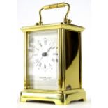 A Till & Bligh London brass cased carriage clock, with swing handle in rectangular single glazed