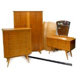 A 1960s/ 70s walnut and burr wood retro bedroom suite, comprising two door wardrobe, chest of five