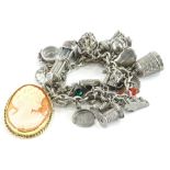 A silver charm bracelet containing various white metal and white coloured metal charms, to include a