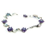 A stone set floral bracelet, with design of floral clusters each set with amethyst and aquamarine