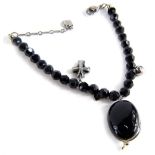 A Swarovski crystal bracelet, with black crystal, with three tiered drops, comprising a locket cross