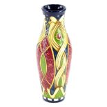A Moorcroft pottery vase, with tubelined decoration in pink, green, beige, on a turquoise ground,
