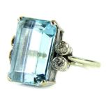 A 9ct white gold aquamarine and diamond dress ring, set with central rectangular cut aquamarine,