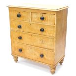 A Victorian scumbled pine chest of drawers, the top with a moulded edge above two short and three