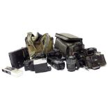 A quantity of camera equipment, to include an Olympus OM101 with added lens and flash, a Pentax P30,